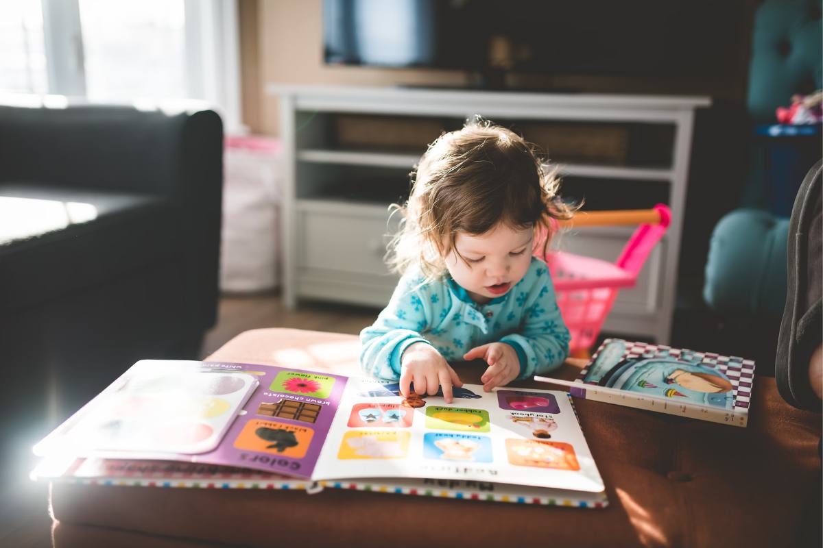 Toddler playing with books