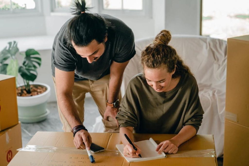 Couple packing and writing an inventory